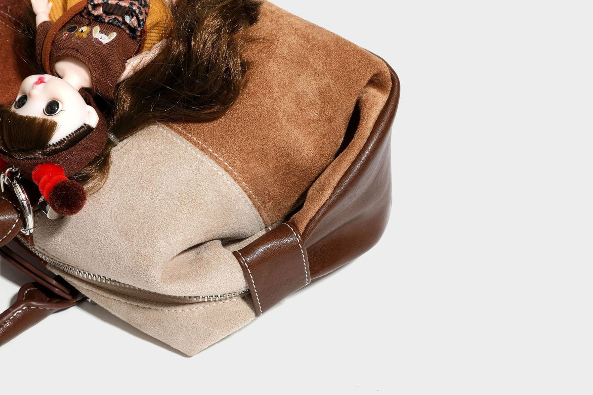 Patchwork suede-look barrel shoulder bag in brown, rust, tan, beige, and gray panels with double leather-look straps and