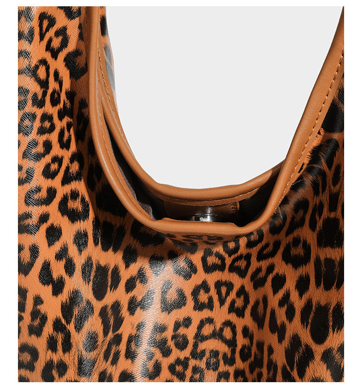 Glossy leopard-print slouchy shoulder bag with long strap and detachable tan zip pouch, detail view 18
