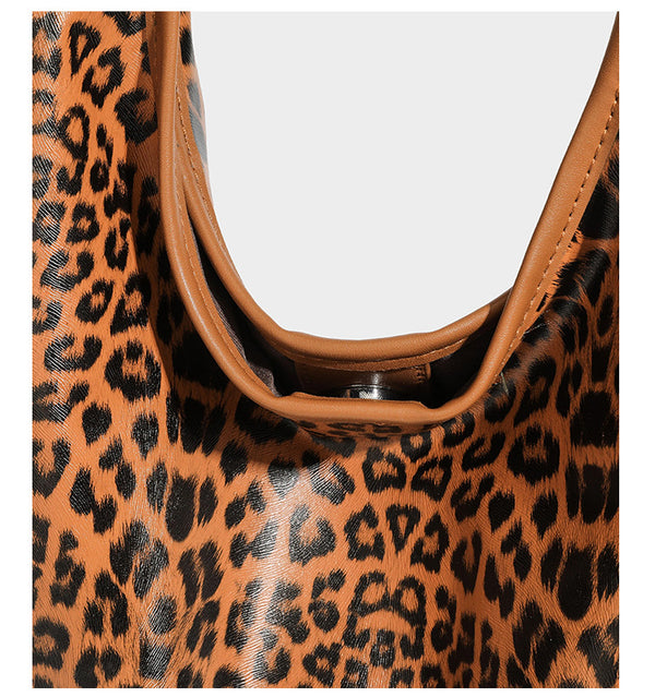 Glossy leopard-print slouchy shoulder bag with long strap and detachable tan zip pouch, detail view 18
