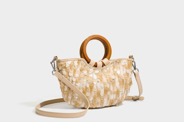 Small sequin half-moon handbag with circular wood-look ring handles and detachable leather-look shoulder strap, detail view
