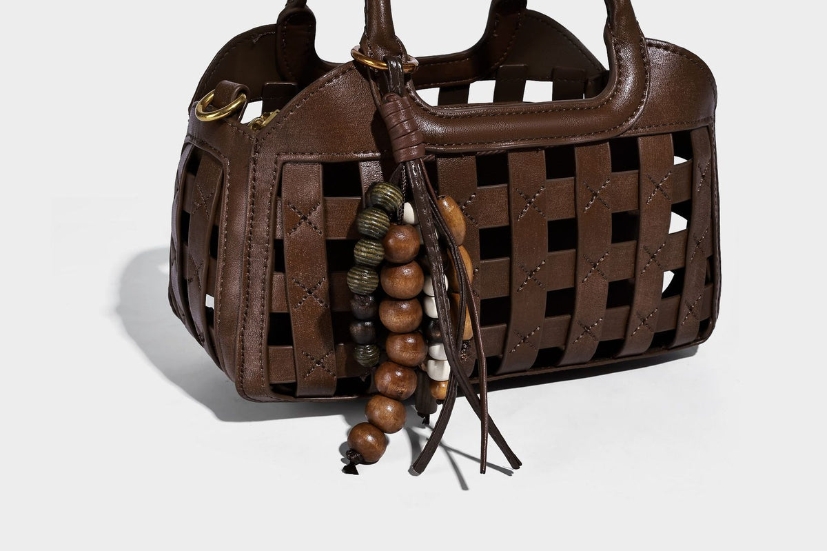 Small structured woven lattice top-handle satchel bag with bead-and-tassel charm and gold-tone hardware, detail view 20