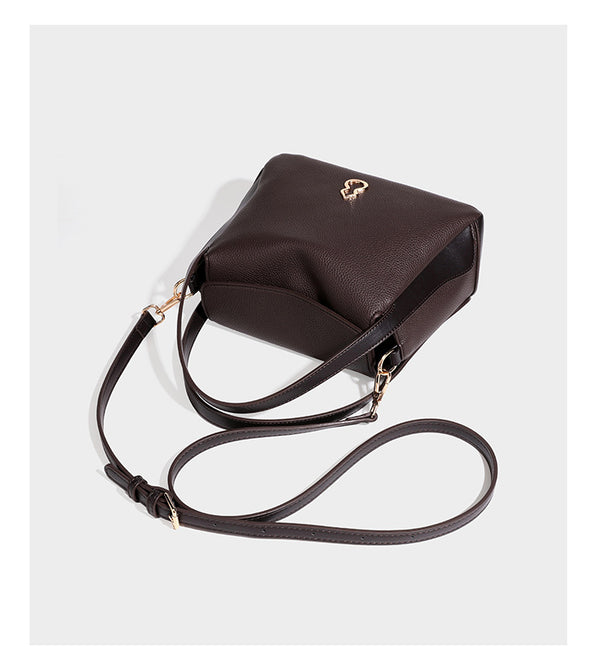 Structured pebbled leather-look shoulder bag with flap top, gold-tone emblem hardware, dual top handles, and detachable