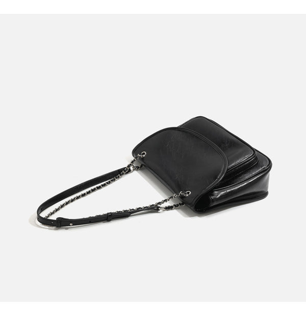 Structured glossy leather-look flap crossbody satchel with woven chain-and-leather shoulder strap, detail view 13