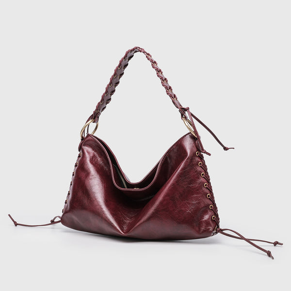 Large slouchy hobo shoulder bag with braided top handle, gold-tone O-ring hardware, and lace-up side cord detailing in