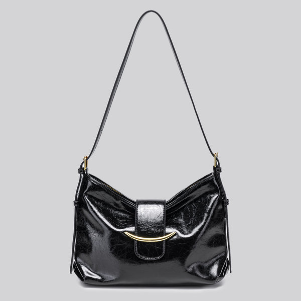 Glossy burgundy leather-look shoulder bag with curved gold-tone bar front closure, crinkled oil-wax texture, and adjustable