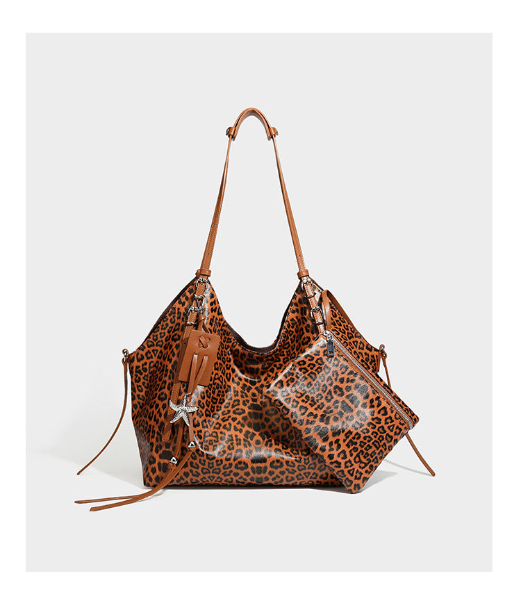 Large leopard print shoulder tote bag with glossy finish, long double straps, front zip pocket, silver-tone hardware, and
