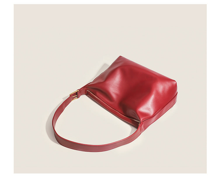 Large slouchy hobo shoulder bag in smooth leather-look finish with single long strap and gold-tone zip closure, detail view