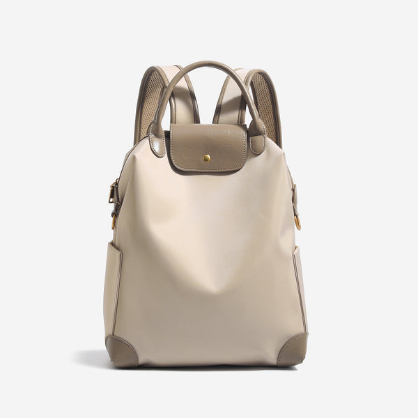 Large matte nylon backpack handbag with cognac leather-look trim, snap flap, and gold-tone hardware, detail view 7