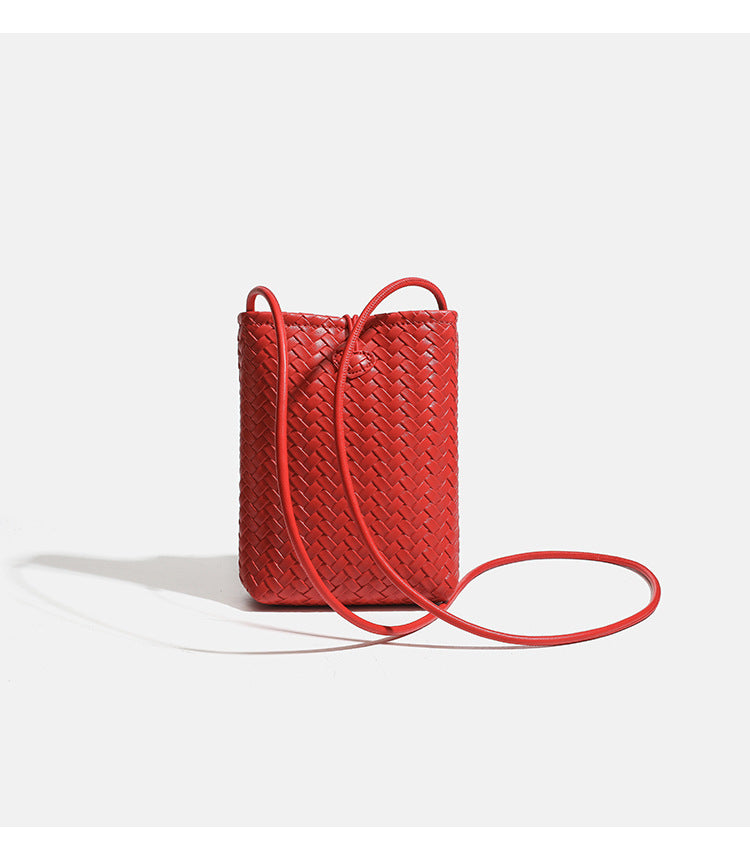 Compact woven leather-look bucket crossbody pouch with toggle closure and long fixed strap, detail view 10