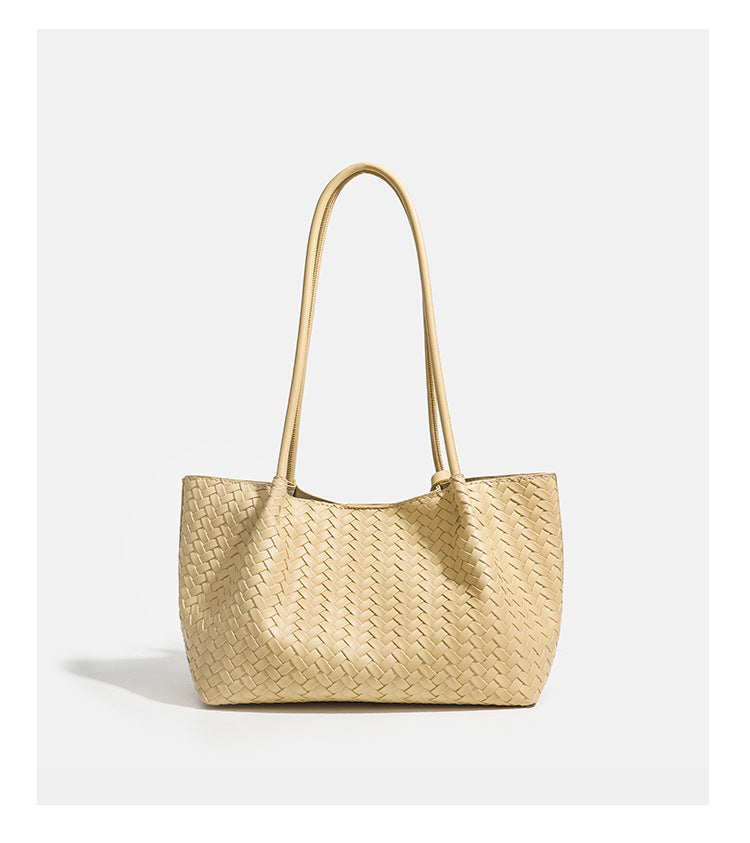 Woven leather-look tote bag in yellow with long shoulder straps, heart-shaped hanging charm, and removable inner zip pouch