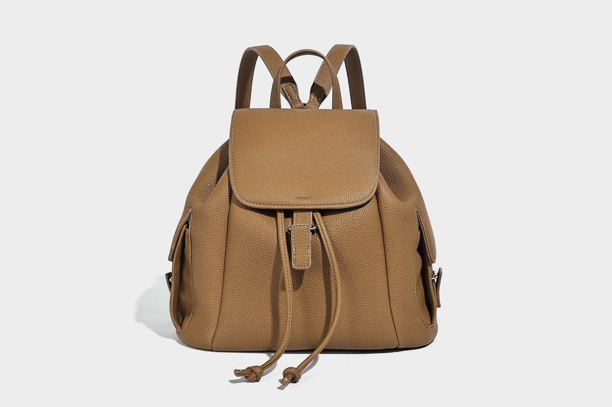 Compact pebbled leather-look flap drawstring backpack handbag with side pockets, top handle, and silver-tone hardware, detail