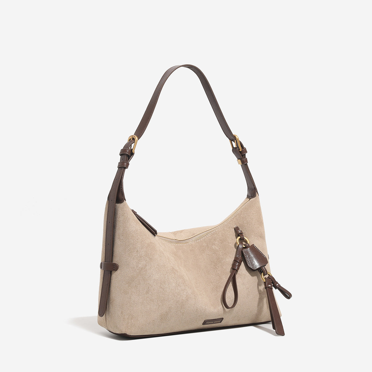 Sand beige slouchy hobo shoulder bag with dark brown trim, adjustable strap, gold-tone hardware, and decorative charm