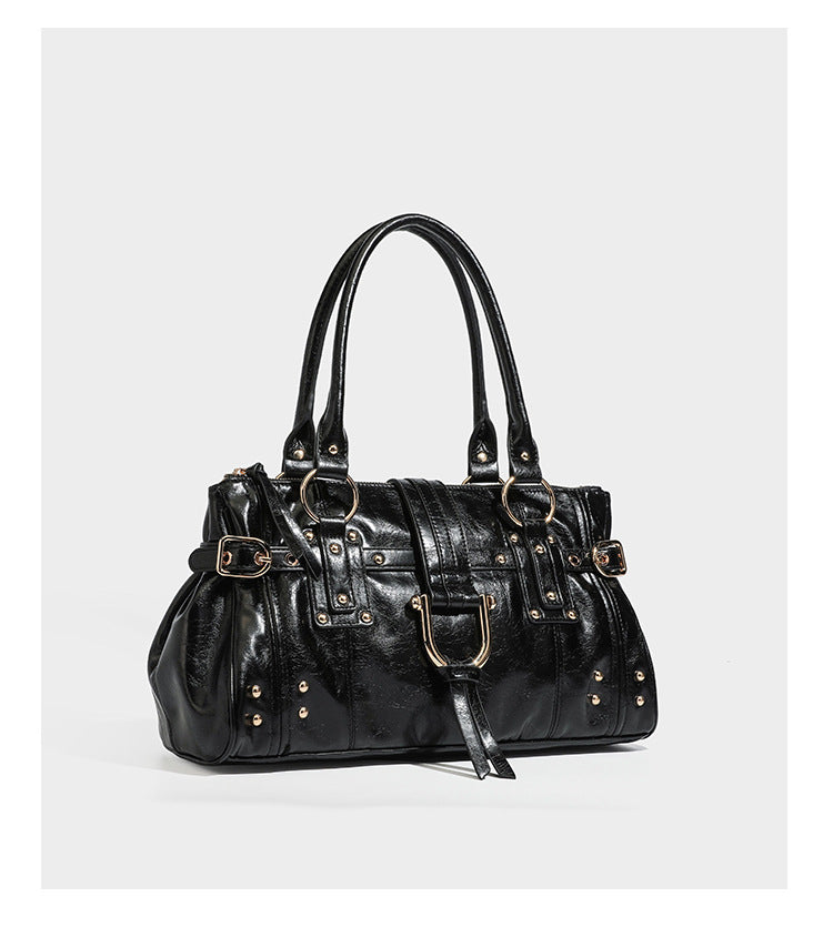 Dark brown glossy leather-look structured satchel tote with gold-tone studs, buckle straps, dual top handles, and detachable