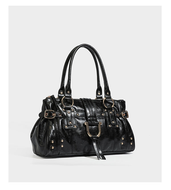 Dark brown glossy leather-look structured satchel tote with gold-tone studs, buckle straps, dual top handles, and detachable