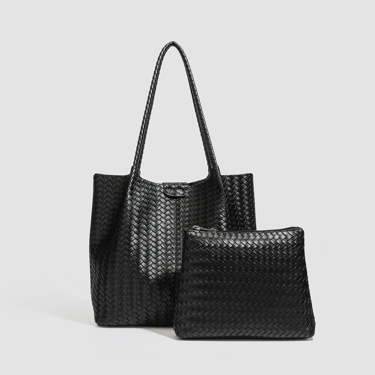 Large black basket-weave leather-look tote bag with long braided shoulder straps and matching woven zip pouch, detail view 3