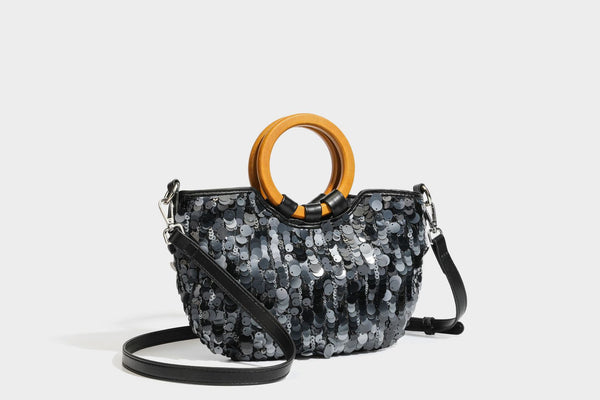 Small sequin half-moon handbag with circular wood-look ring handles and detachable leather-look shoulder strap, detail view