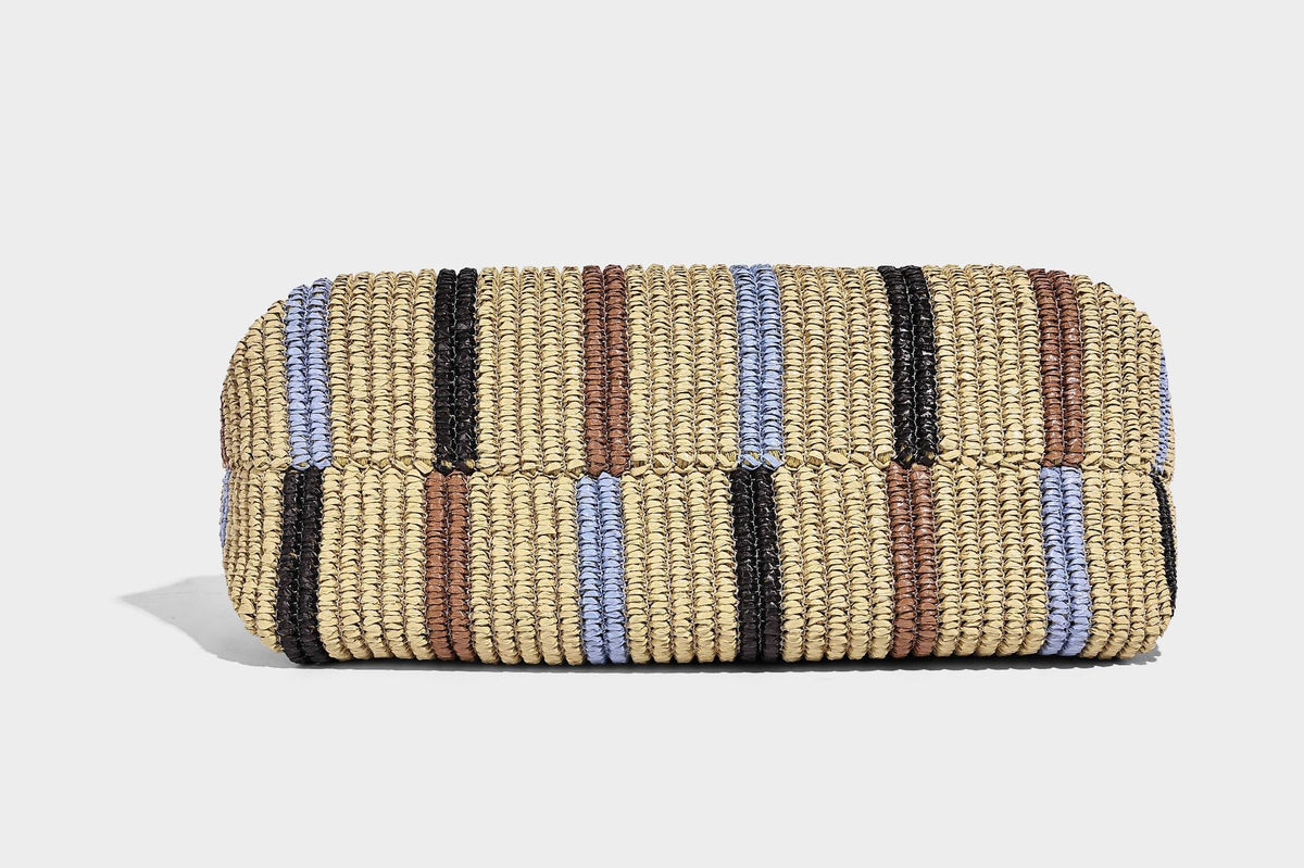 Slouchy woven straw hobo shoulder bag with beige, black, brown, and blue vertical stripes and brown leather-look trim, detail