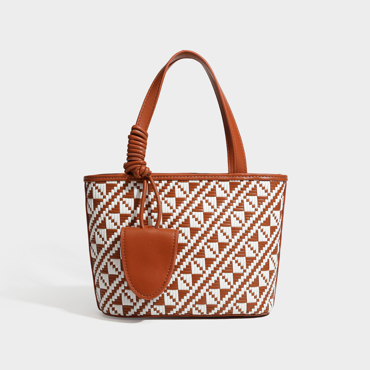 Kleiner, strukturierter Shopper mit gewebtem geometrischem Muster, glatten Besätzen in Lederoptik, geknoteten Henkeln, Reißverschluss und herabhängendem Frontdetail