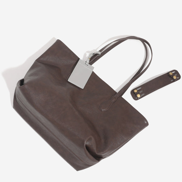 Large leather-look tote bag with trapezoid silhouette, double shoulder straps, and detachable hanging tag, detail view 3