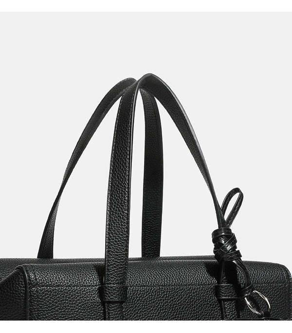 Structured pebbled leather-look top-zip barrel bag with dual handles, detachable shoulder strap, and attached croc-pattern
