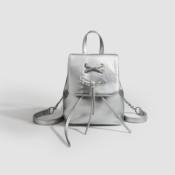 Kleine Rucksack-Handtasche in Lederoptik mit über Kreuz geschnürter Schleife auf der Klappe, Schulterriemen mit Kettendetail und Tragegriff