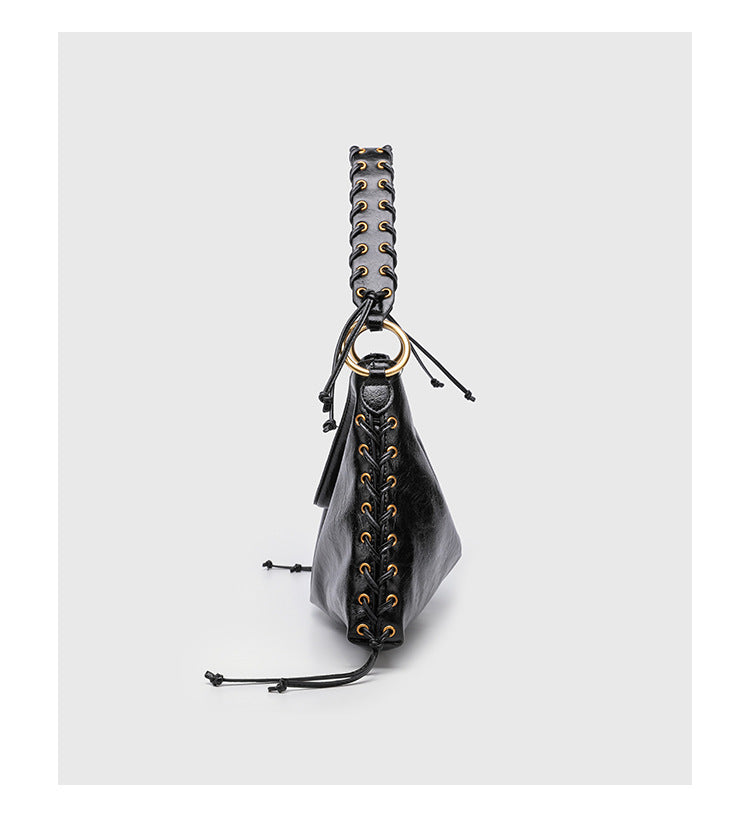 Large slouchy hobo shoulder bag with braided top handle, gold-tone O-ring hardware, and lace-up side cord detailing in