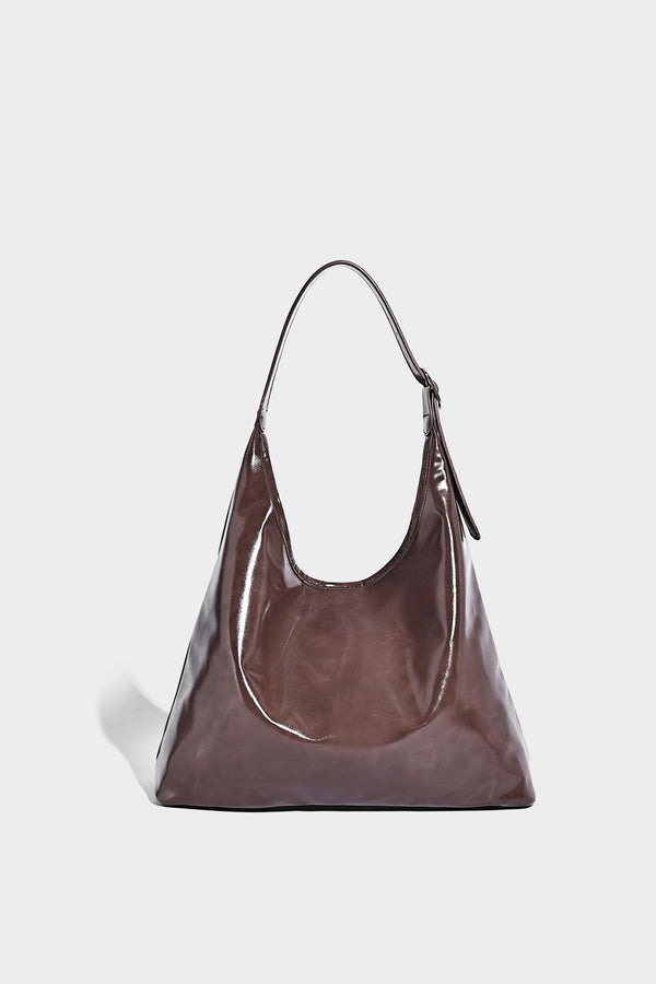 Glossy slouchy hobo shoulder bag with adjustable strap and embossed floral emblem, detail view 20