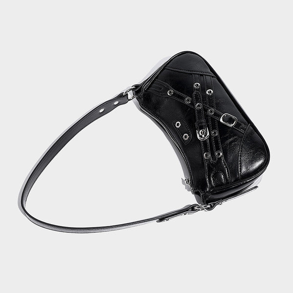 Compact moto-inspired shoulder bag with crisscross grommet strap detail, glossy textured finish, and adjustable crossbody
