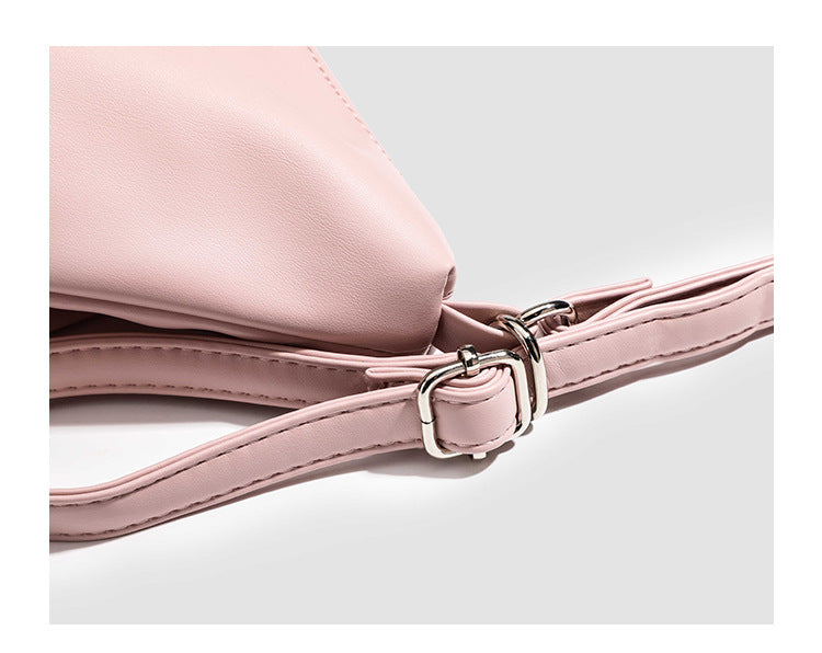 Glossy leather-look hobo shoulder bag with front bow lacing detail and silver-tone chain strap, detail view 11