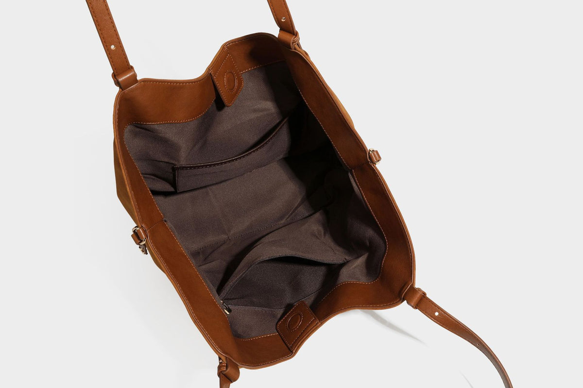 Oversized suede-finish tote shoulder bag in caramel brown with slim leather-look straps and gold-tone logo hardware, detail