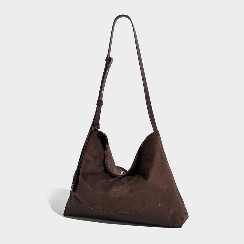 Dark brown slouchy hobo bag with matte suede-look body, smooth leather-look base trim, adjustable shoulder strap, and, front