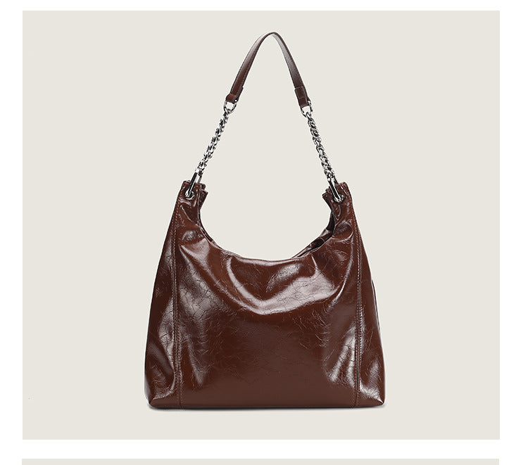 Glossy crinkled leather-look slouchy hobo bag with silver chain-and-leather shoulder strap and open top, detail view 13