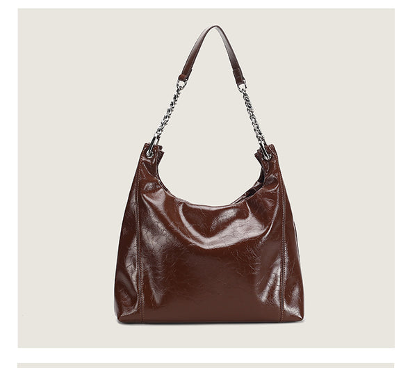 Glossy crinkled leather-look slouchy hobo bag with silver chain-and-leather shoulder strap and open top, detail view 13