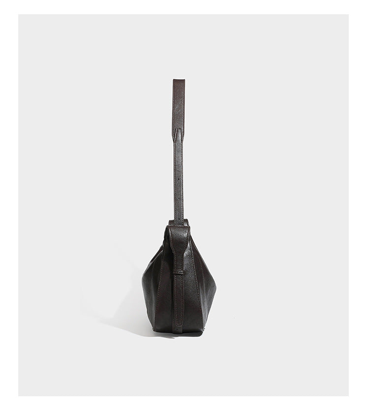Slouchy crescent hobo shoulder bag in dark brown pebbled leather-look finish with zip top and long shoulder strap, detail