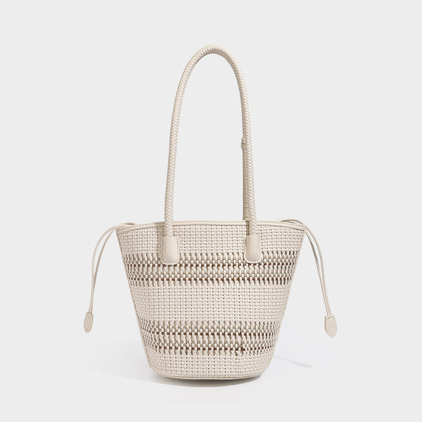 Structured woven bucket tote bag in pastel blue with braided shoulder strap, open lattice weave body, cream drawstring