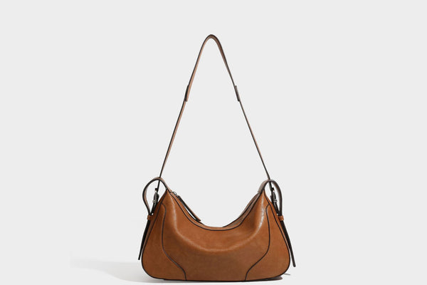 Slouchy crescent hobo shoulder bag in dark brown pebbled leather-look finish with zip top and long shoulder strap, detail