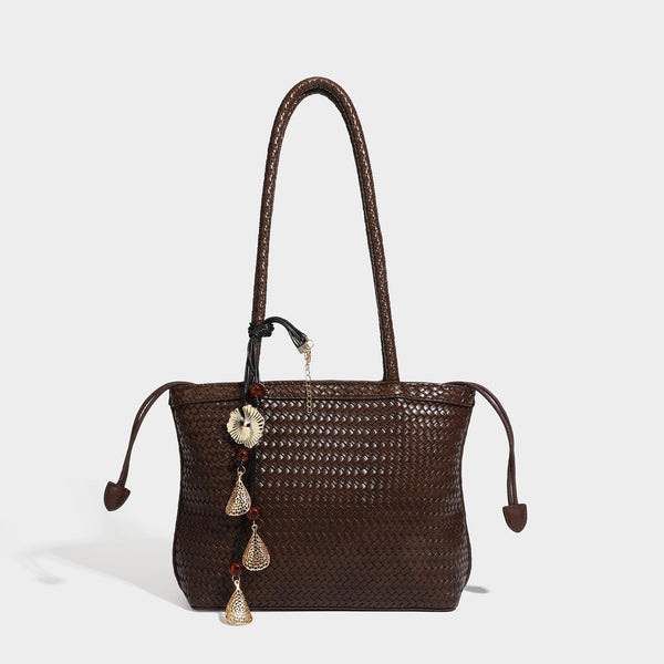 Structured woven leather-look tote bag in dark brown with long shoulder straps, side drawstring ties, and gold filigree