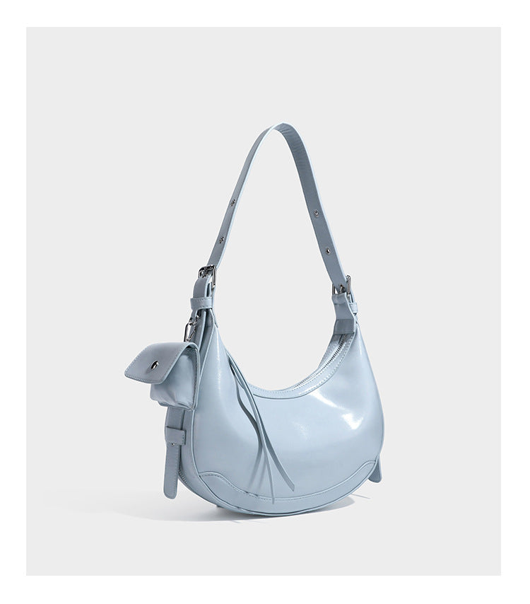 Glossy leather-look crescent hobo shoulder bag with dark contrast trim, silver-tone hardware, and attached mini flap pouch