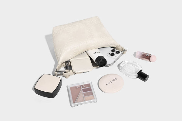 Small embossed half-moon shoulder bag with top zipper, detachable front pouch, and adjustable slim strap, detail view 17