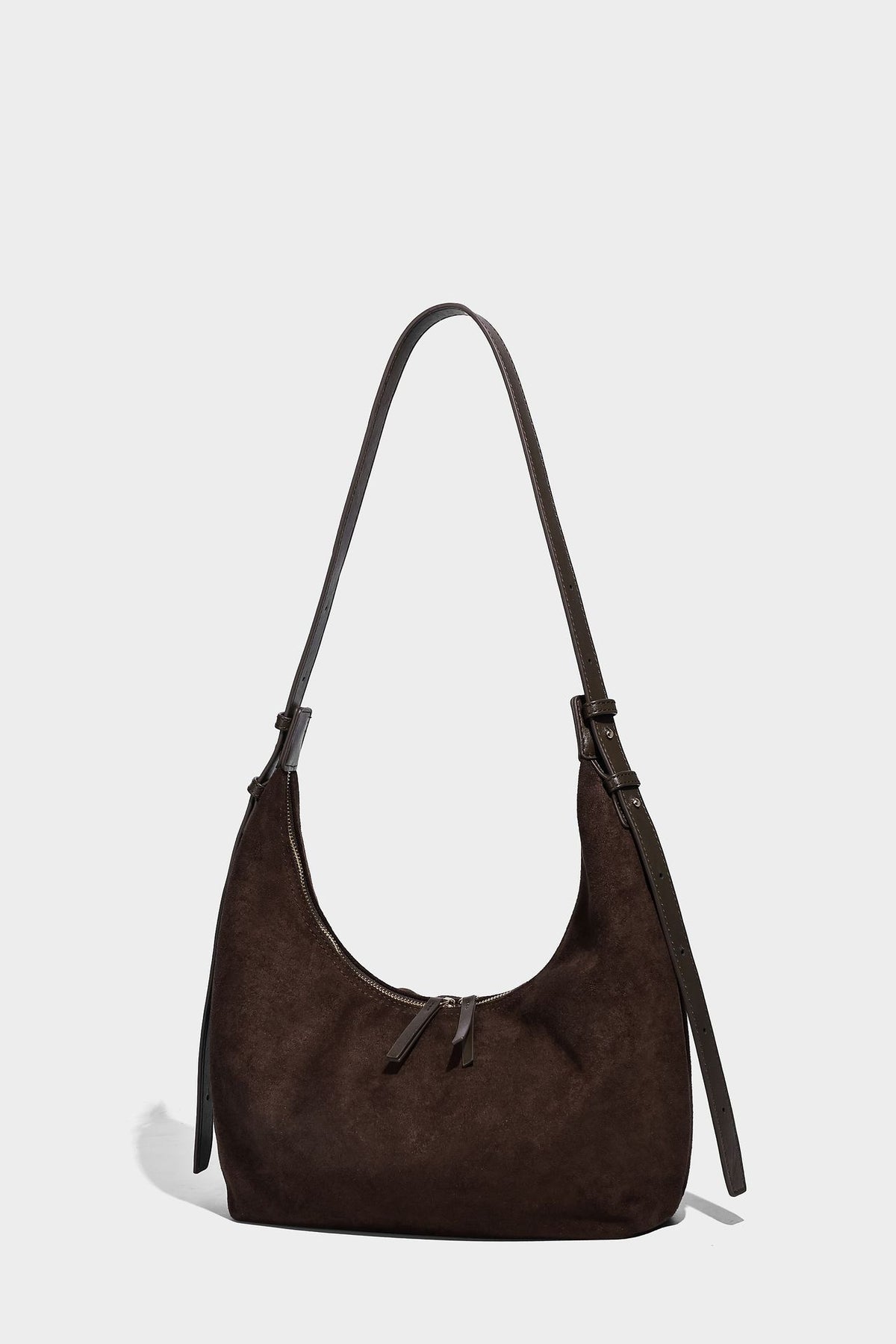 Slouchy crescent hobo shoulder bag in dark chocolate matte suede-look finish with adjustable strap and twin-pull top zip