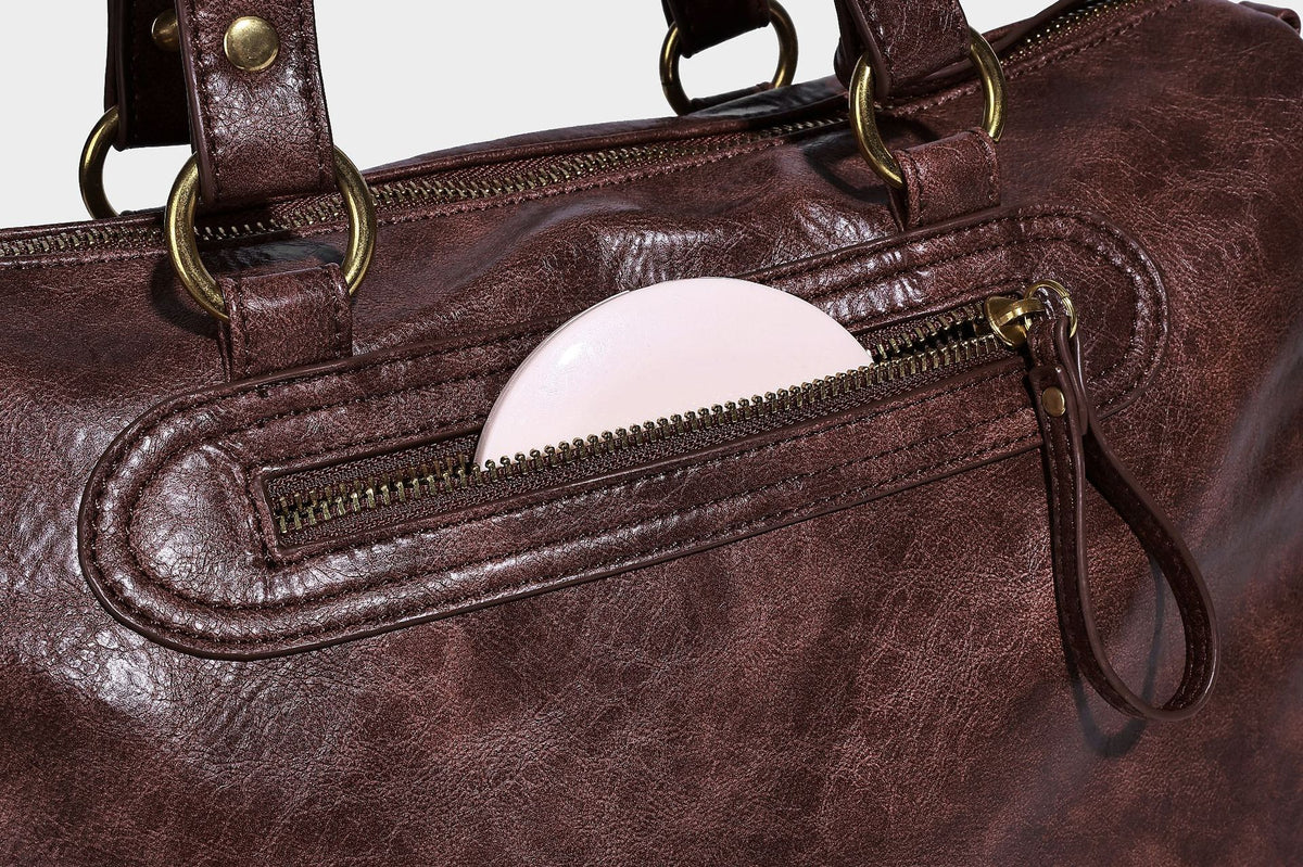Distressed leather-look vintage satchel shoulder bag with multiple front zip pockets, dual top handles, and brass-tone