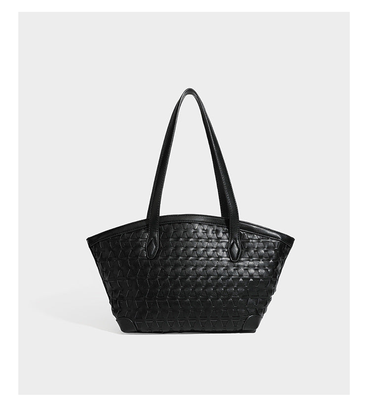 Large leather-look tote bag with geometric woven emboss, double shoulder straps, and round woven cord charm in brown, detail