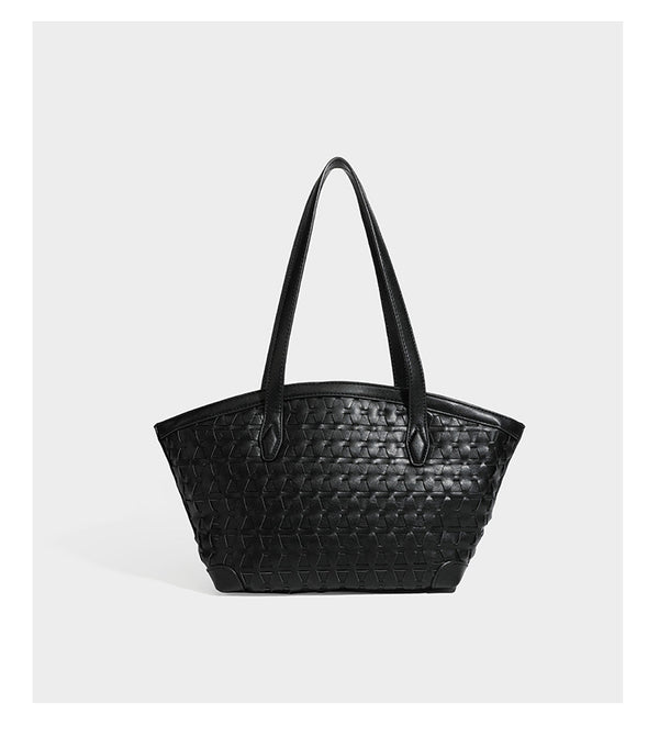 Large leather-look tote bag with geometric woven emboss, double shoulder straps, and round woven cord charm in brown, detail