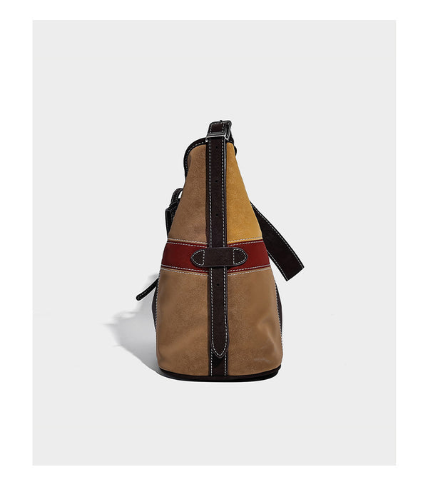 Patchwork bucket tote shoulder bag with tan, dark brown, olive, red, and sky blue color-block panels, white contrast, detail