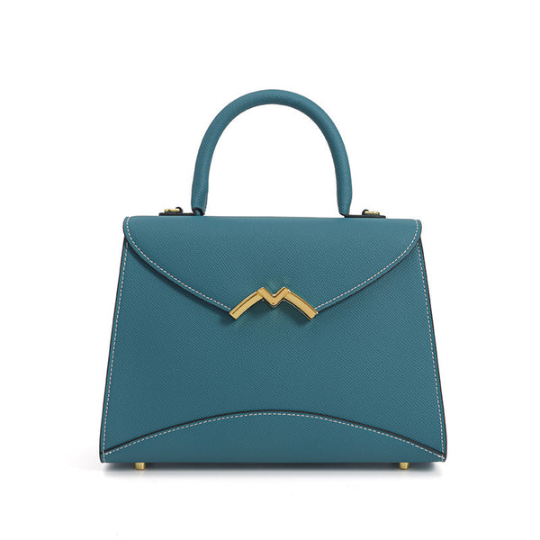 Structured trapezoid top-handle satchel in golden brown cross-grain textured finish with gold M-shaped clasp hardware and