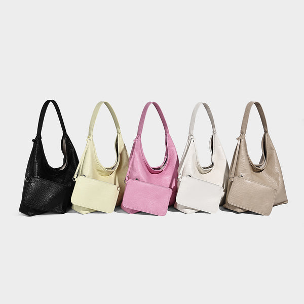 Slouchy hobo shoulder bag in pale yellow glossy pebbled leather-look finish with single shoulder strap and detachable front