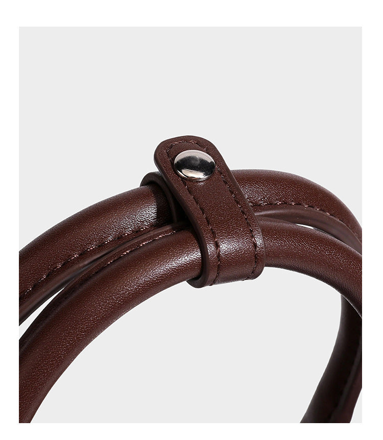 Small structured satchel bag in dark brown velvet-like textured finish with leather-look trim, silver-tone turn-lock bar