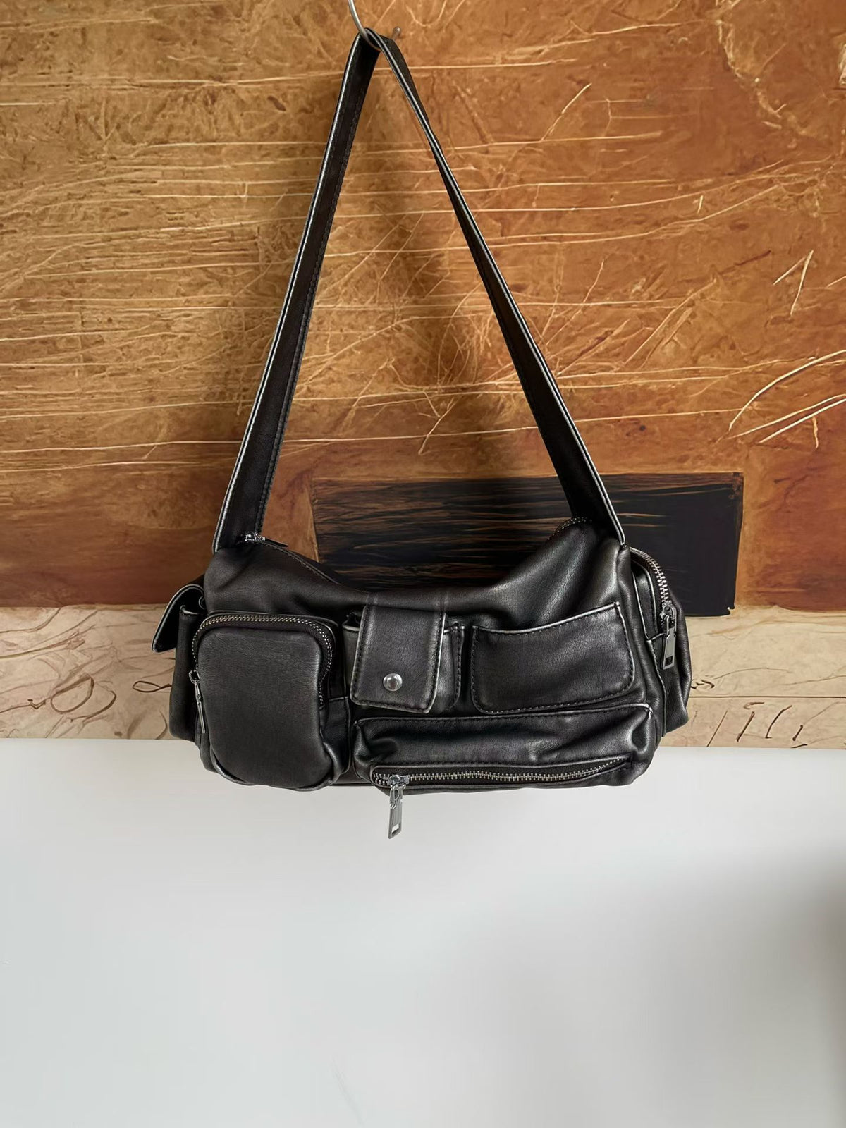 Slouchy multi-pocket leather-look shoulder bag with silver-tone hardware and adjustable strap, detail view 9