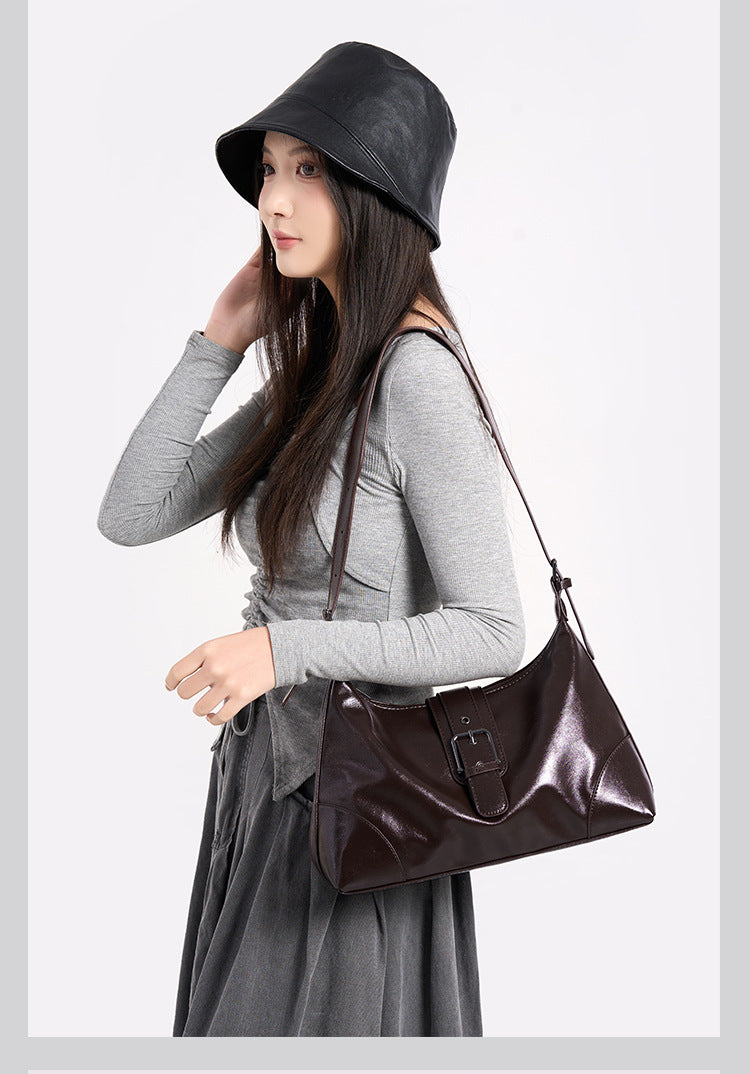 Glossy dark brown slouch hobo shoulder bag with front buckle strap panel and long adjustable single strap, detail view 8