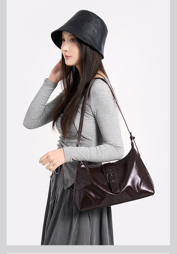 Glossy dark brown slouch hobo shoulder bag with front buckle strap panel and long adjustable single strap, detail view 8